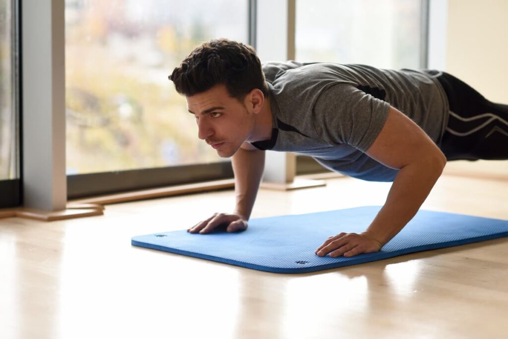 "Man doing push-ups – Gain Strength at Home with Joint-Safe Training"